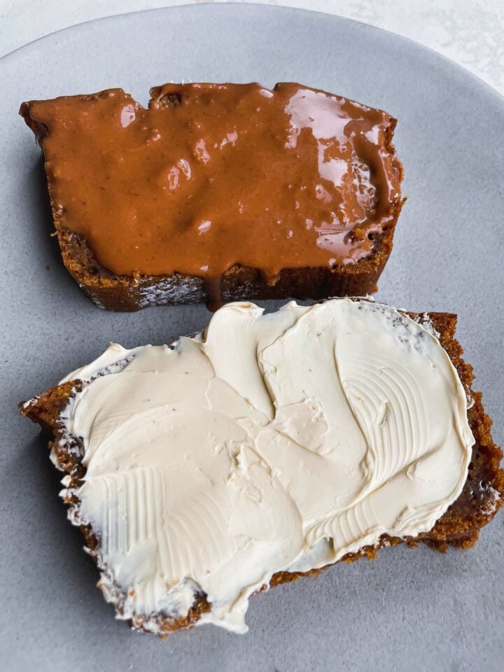 Two slices of vegan pumpkin bread with nut butter