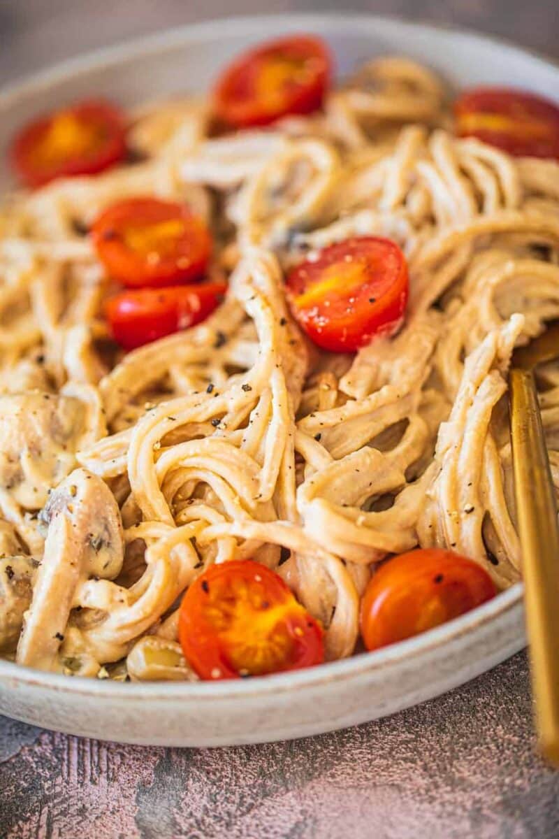 Plate with vegan spaghetti and a creamy sauce