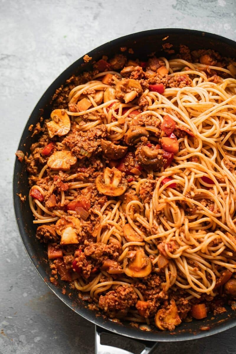 Vegan Bolognese sauce with spaghetti in a large pan