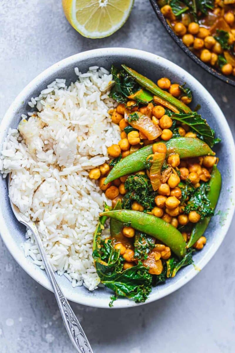 Vegan chickpea curry with snap peas in a blue bowl