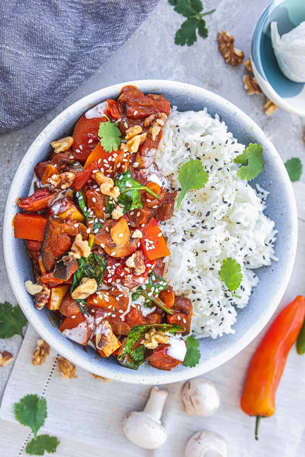 Bowl of vegetable curry over a bed of rice