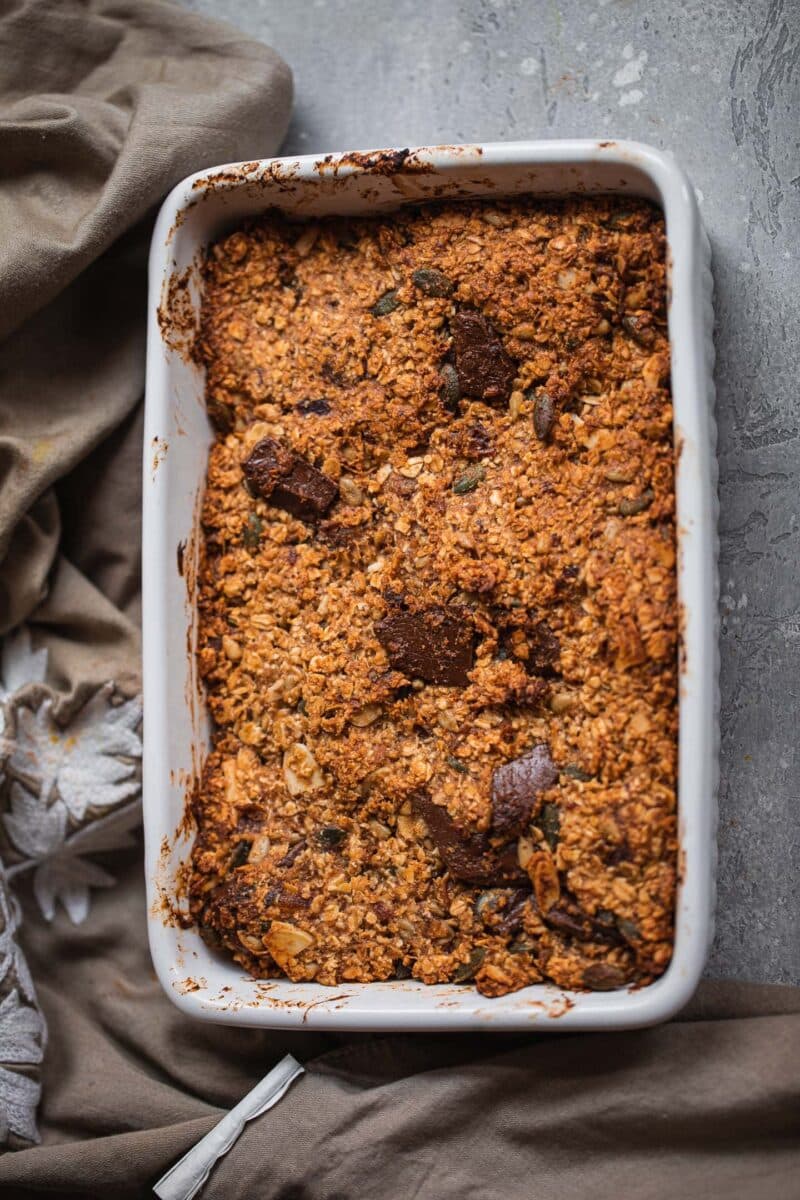 Vegan granola bars with chocolate in a baking dish