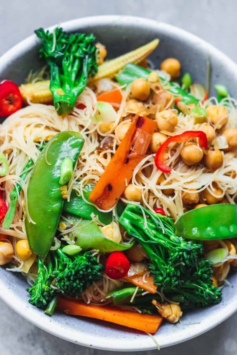 Blue bowl with noodles chickpeas and vegetables