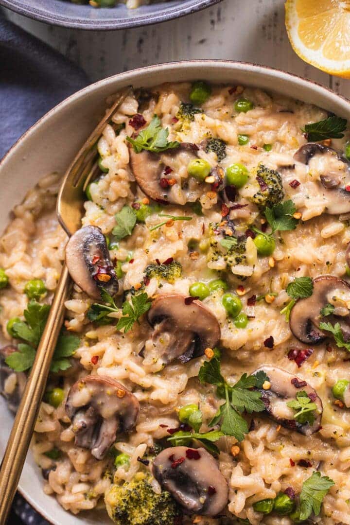 Vegan risotto with vegetables and green peas