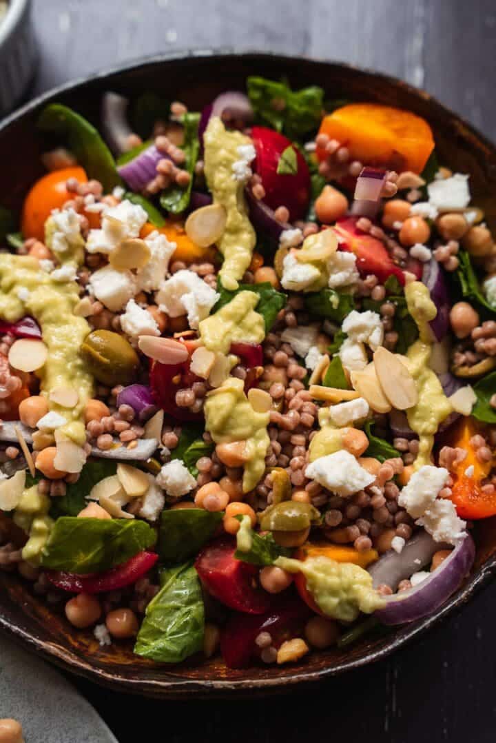 Vegan salad with couscous, vegetables and avocado dressing