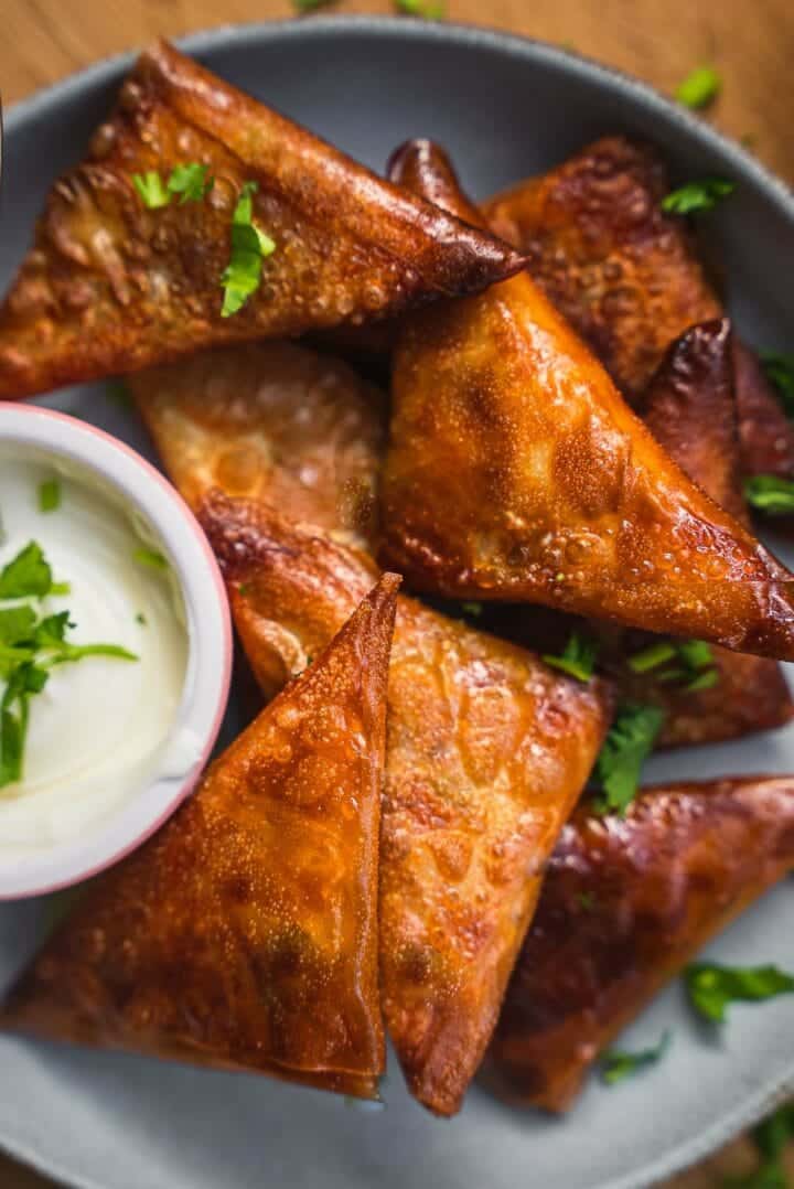 Vegan samosas with a yogurt dip