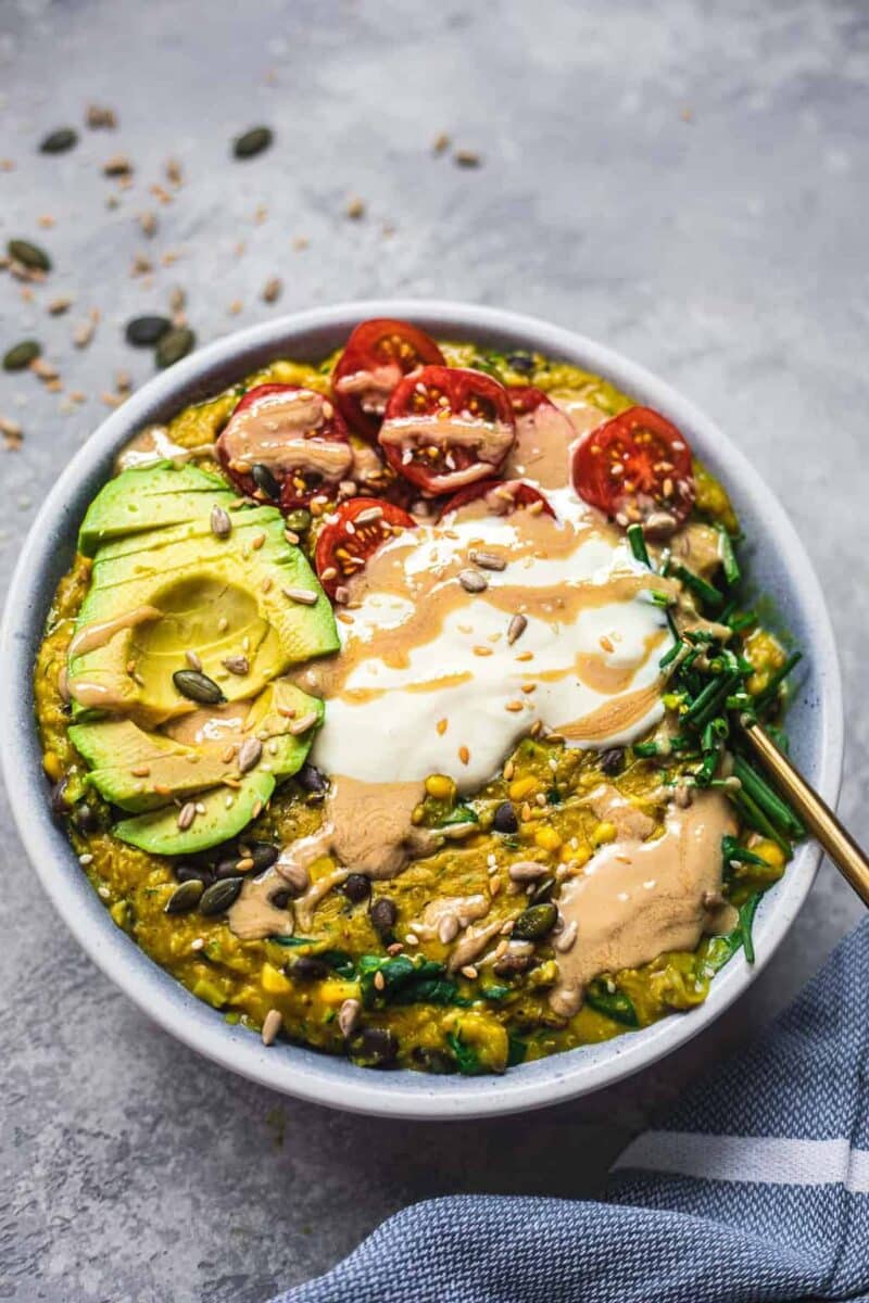 Bowl of vegan oats with avocado and tomatoes