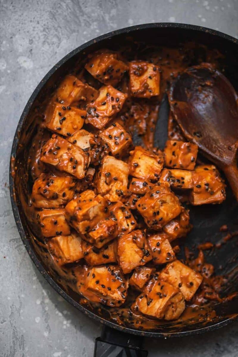 Tofu in a sesame peanut sauce in a frying pan