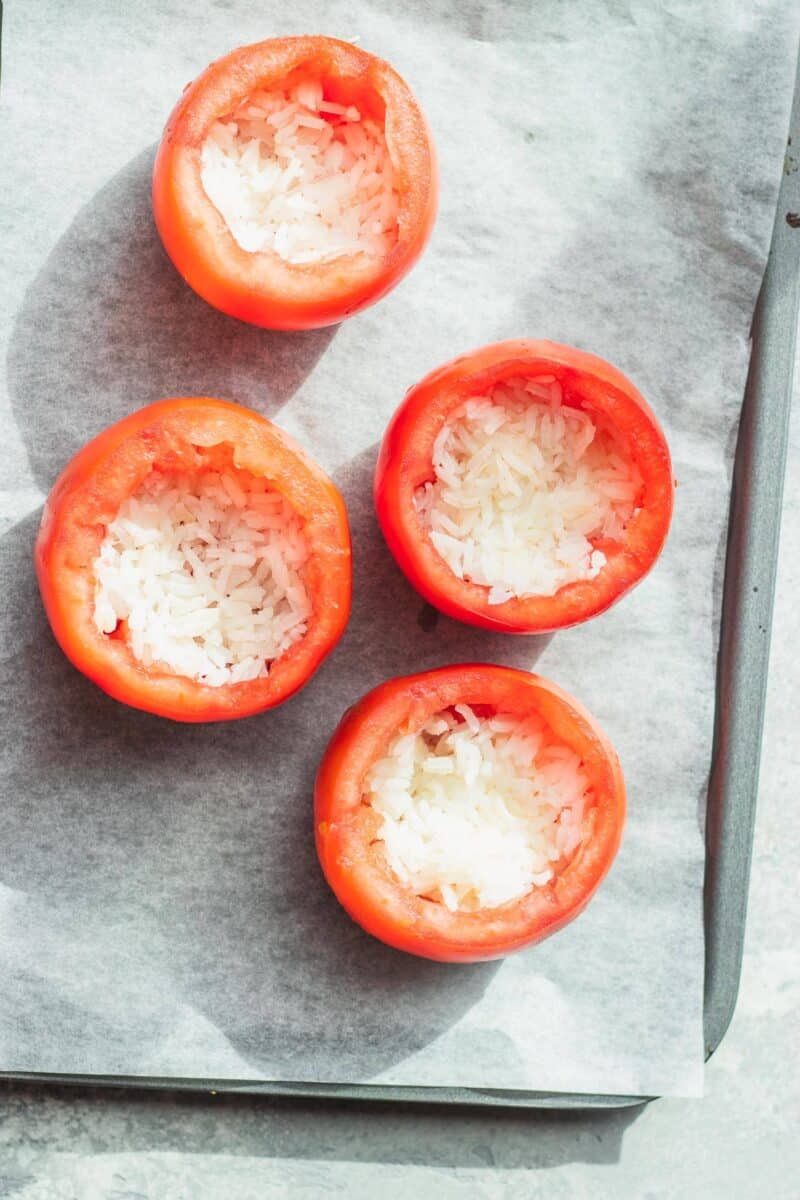Stuffed tomatoes with rice on a baking tray