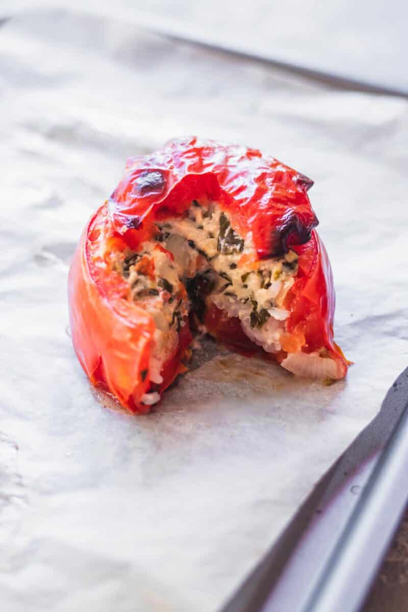 Vegan stuffed tomato on a baking tray