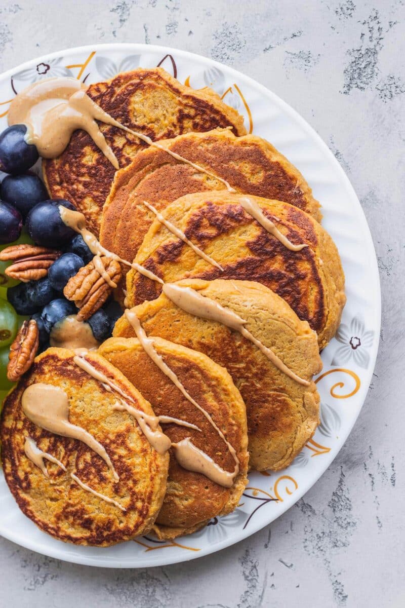 Pancakes on a white plate with peanut butter