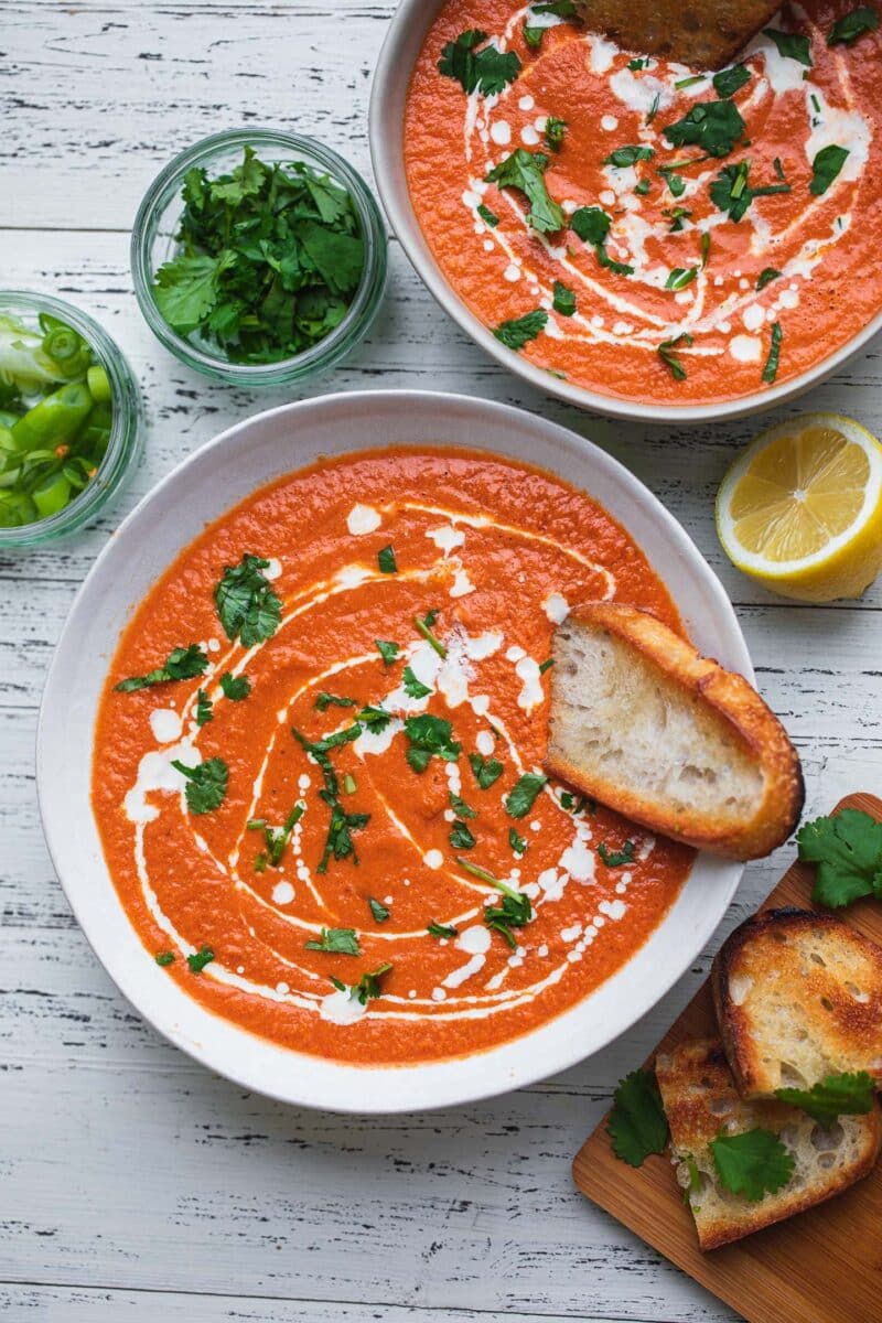 Vegan tomato bisque with bread and herbs