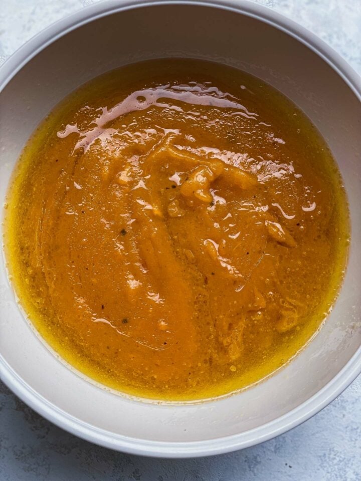 Wet ingredients for pumpkin bread in a mixing bowl
