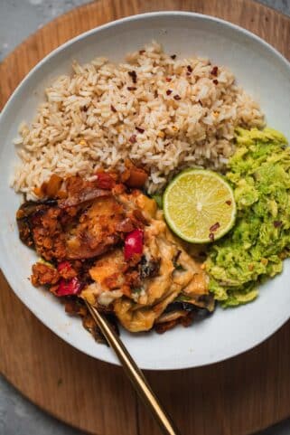Wholegrain rice, vegan Moussaka and avocado in a bowl