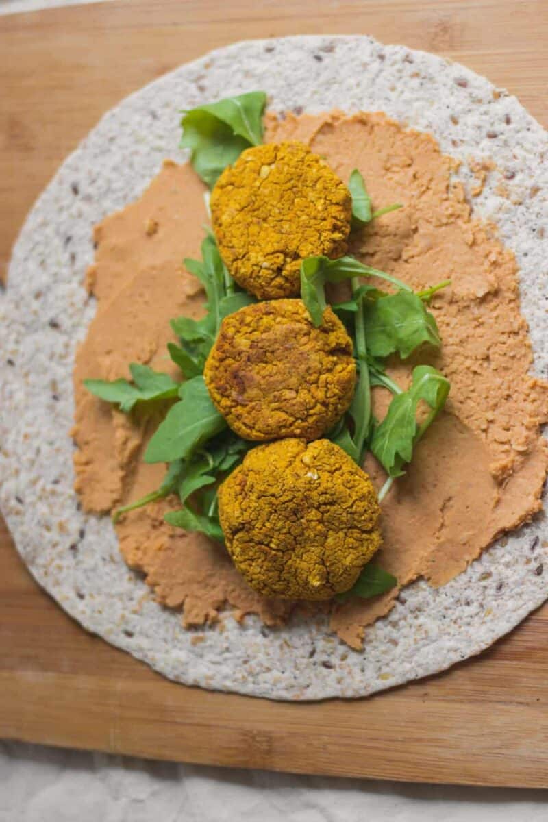 Tortilla with hummus, baked falafels and arugula