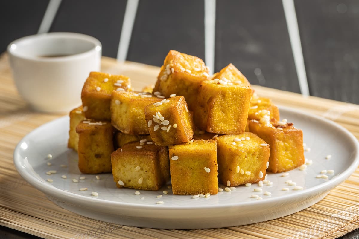 stack of easy marinated tofu on a white plate side view