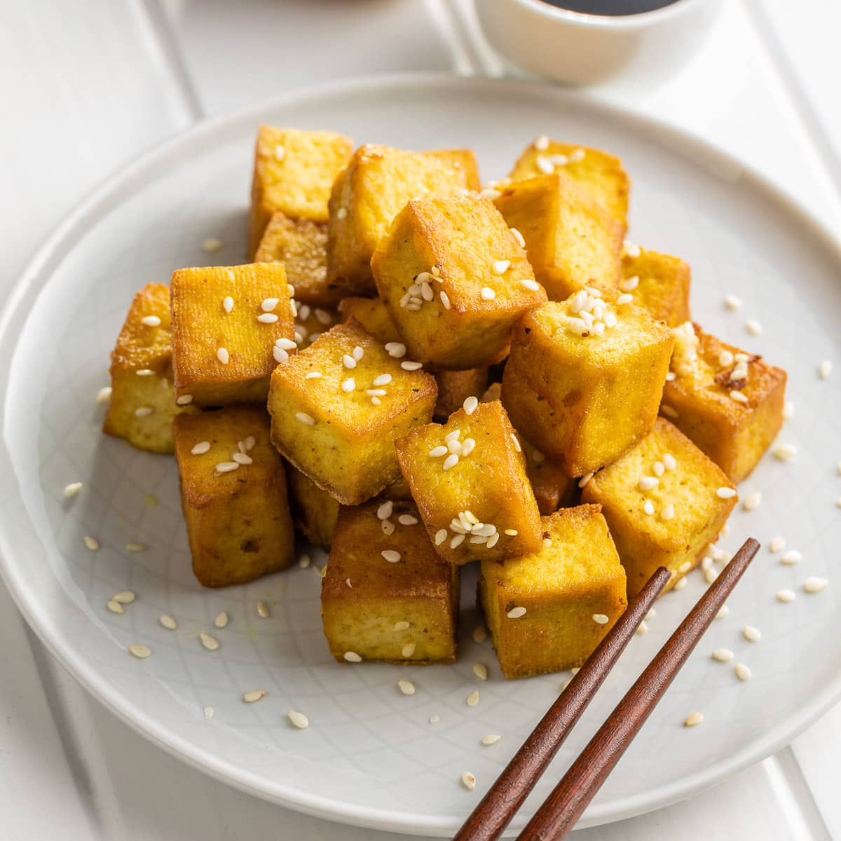 top view close up stack of easy marinated tofu on a white plate