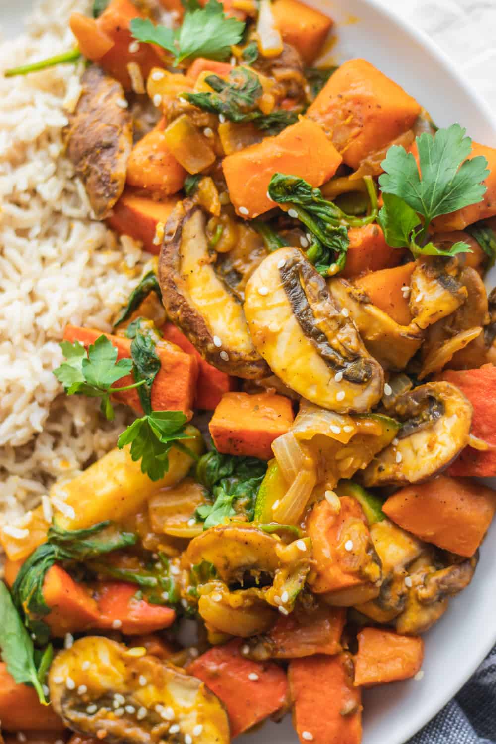 Close-up of gluten-free vegan pumpkin stir-fry with sesame seeds and herbs