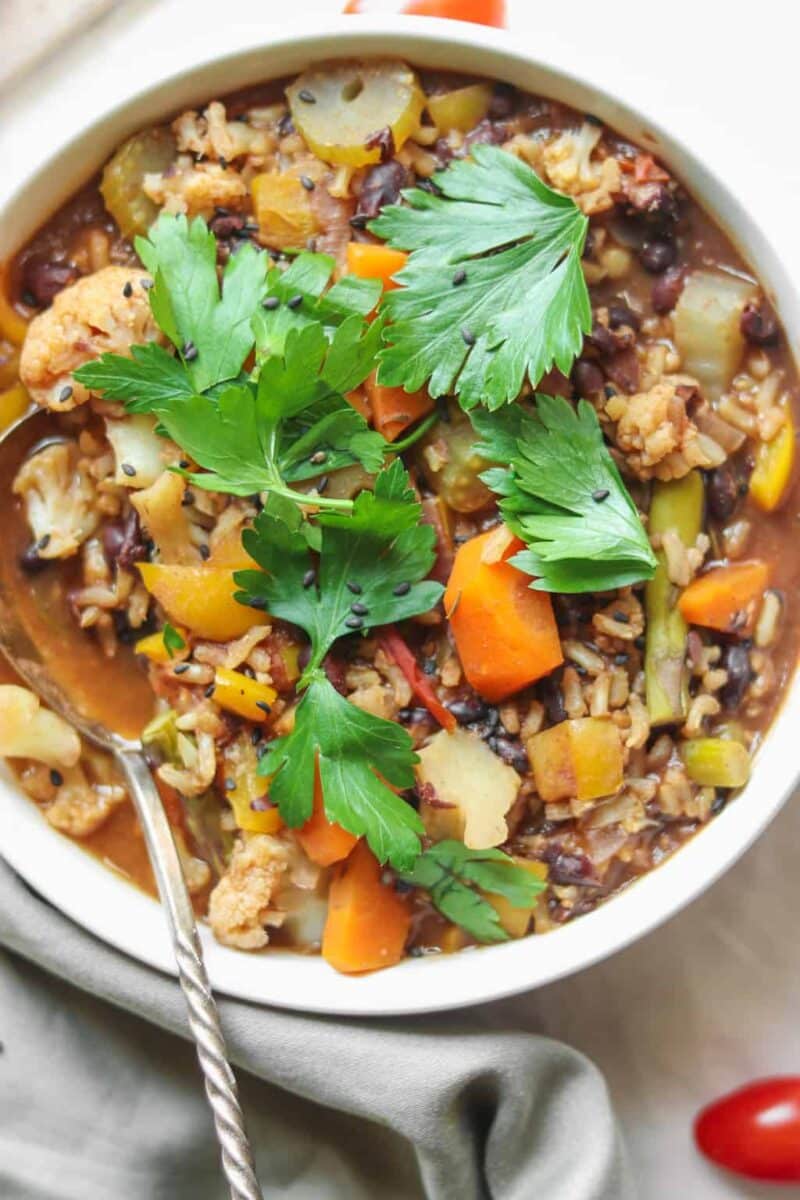 Vegan rice soup with black beans and vegetables