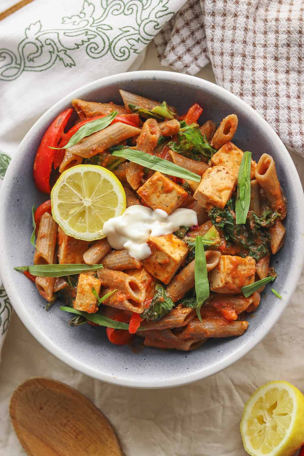 Bowl of creamy vegan pasta with tomato sauce and tofu