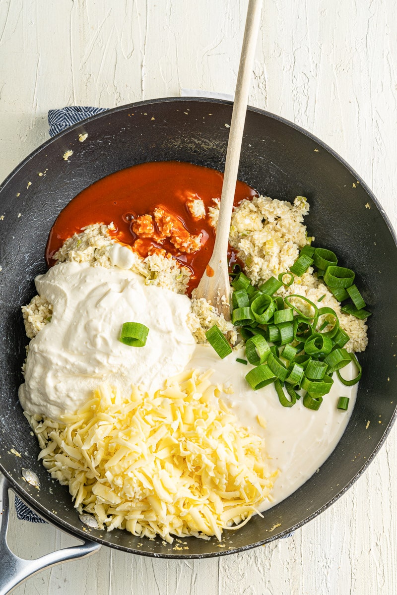 ingredients for buffalo cauliflower dip in a large skillet
