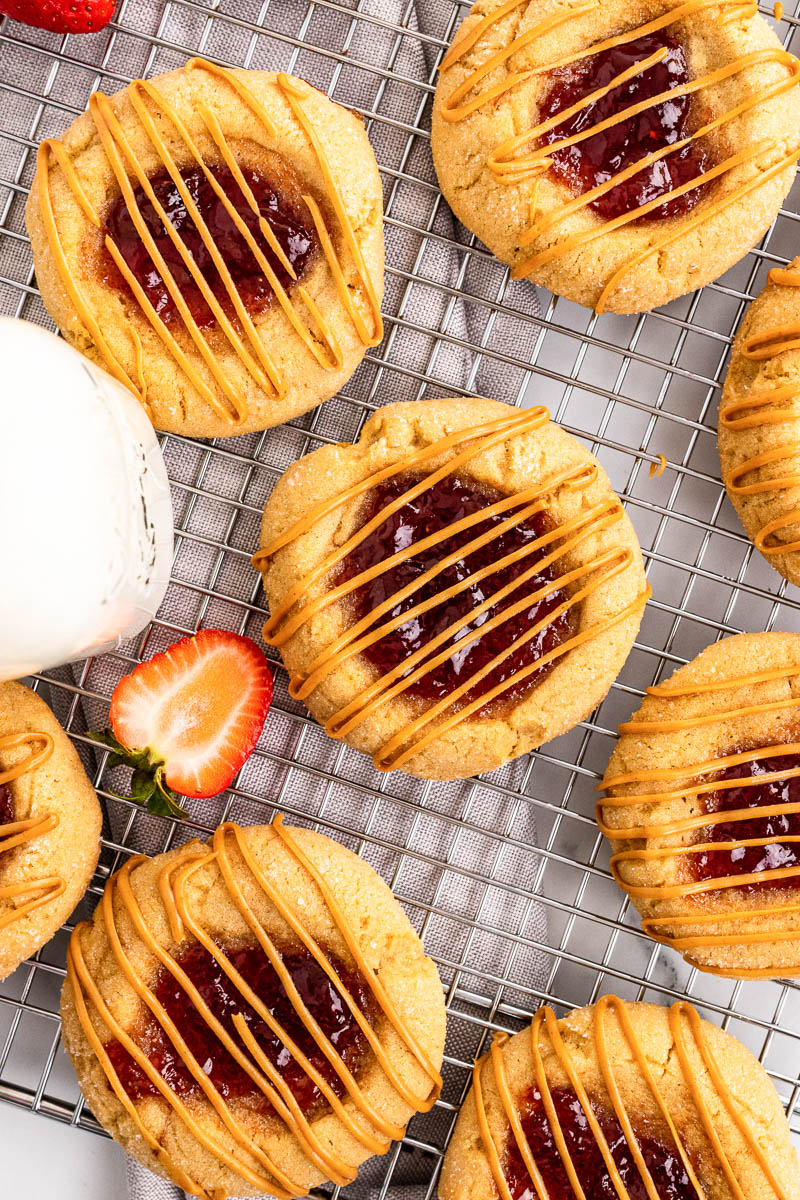 peanut butter and jelly cookies lying flat on cooling rack