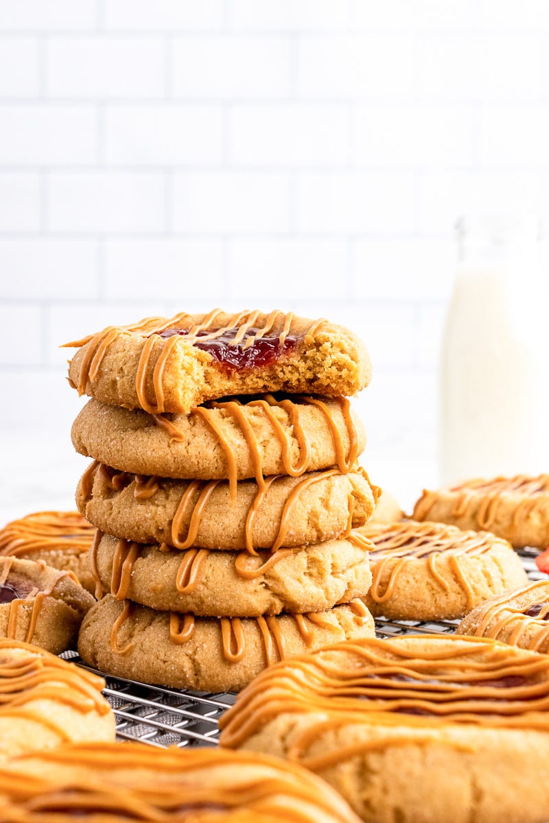 peanut butter and jelly cookies stacked on cooling rack