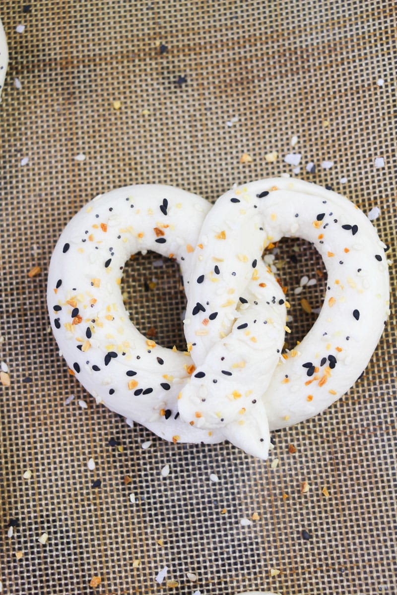 unbaked homemade soft pretzel with seasoning