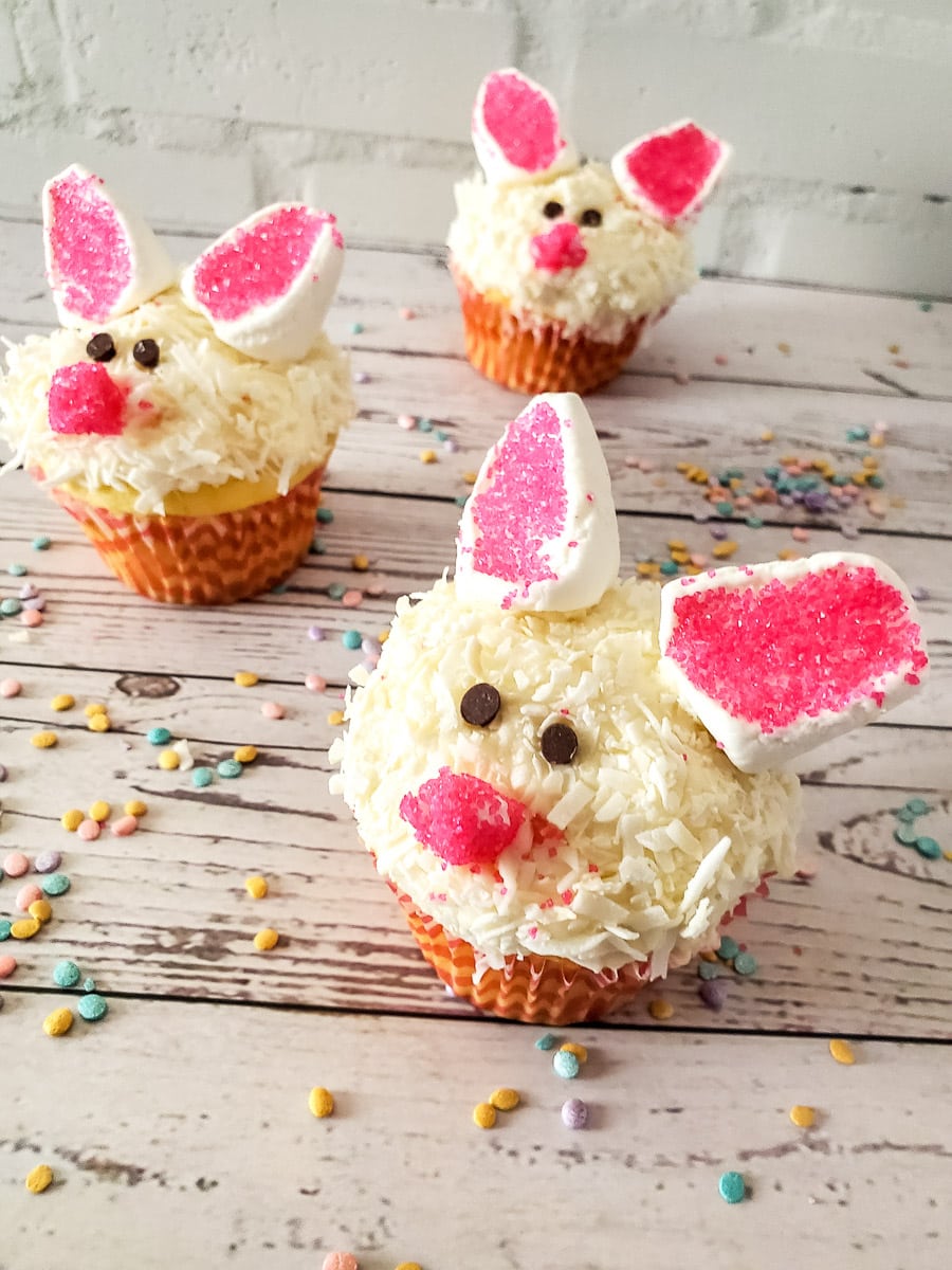 three decorated easter bunny cupcakes