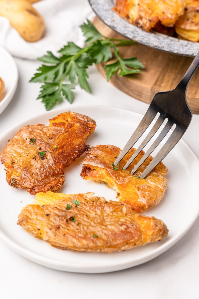 eating the smashed fingerling potatoes with a fork