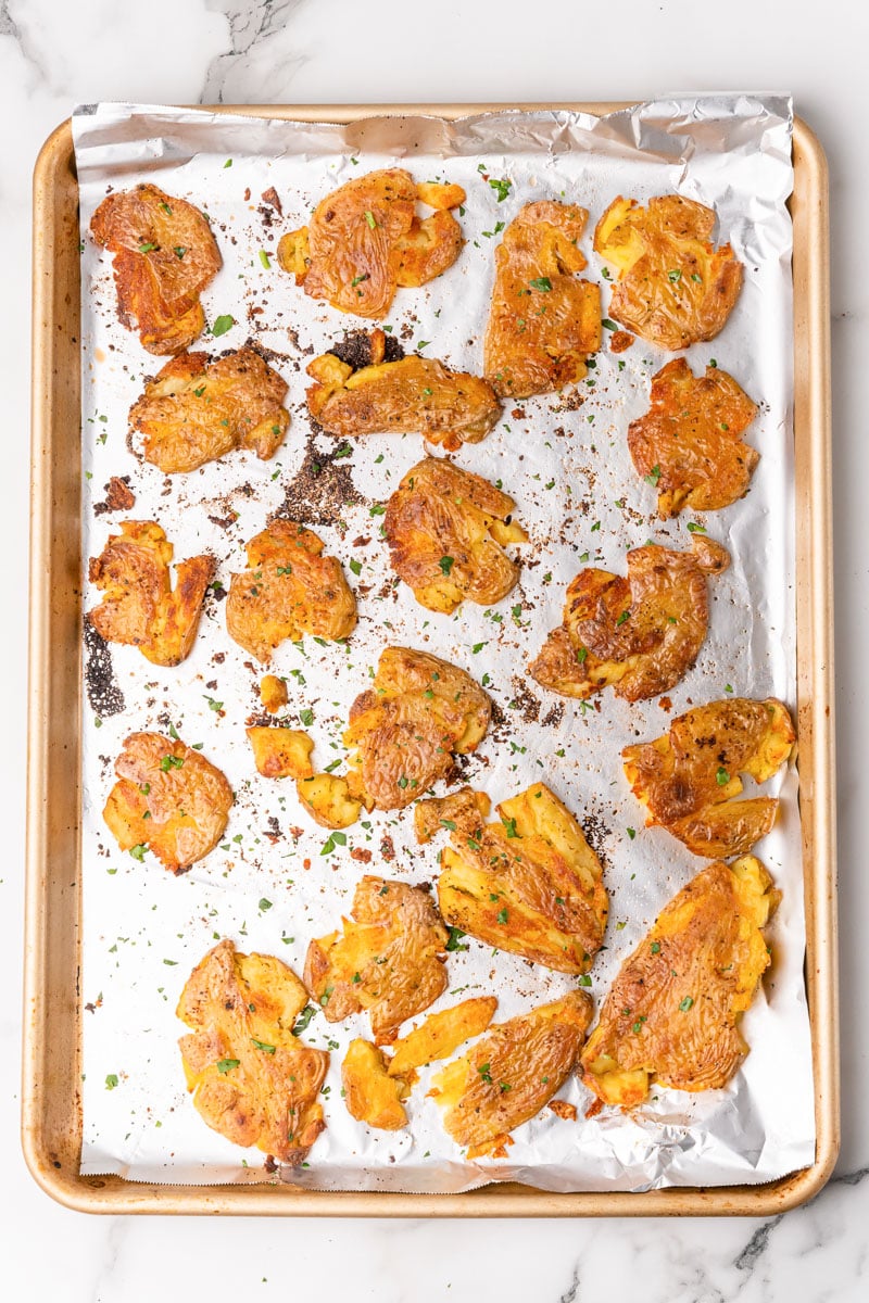 smashed fingerling potatoes on a baking sheet