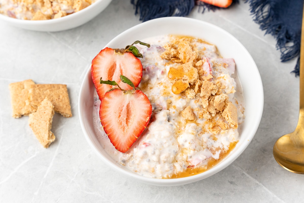 overnight oats being served with strawberries