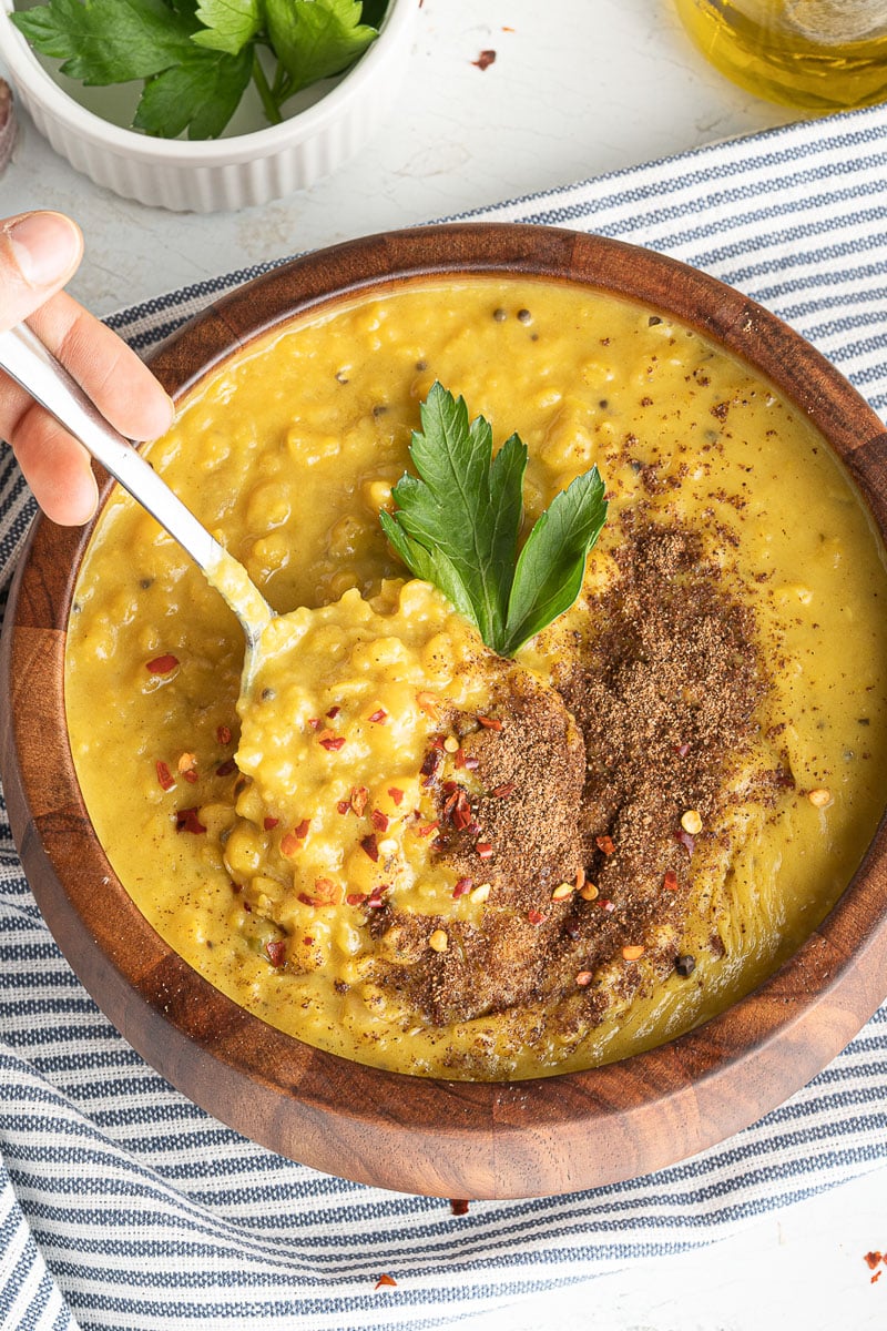 close up bowl of on-pot coconut lentil curry with spoon