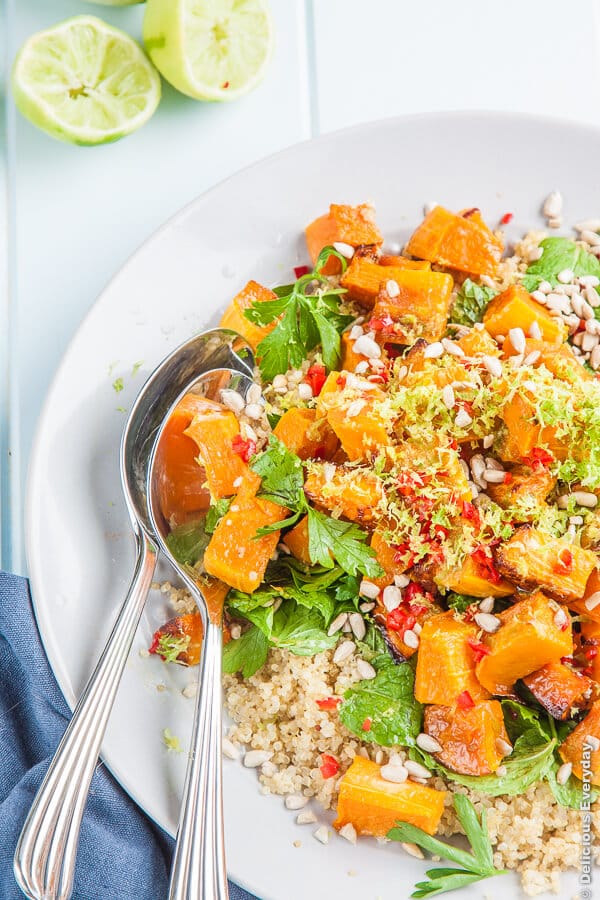 spoons in a bowl of pumpkin quinoa salad