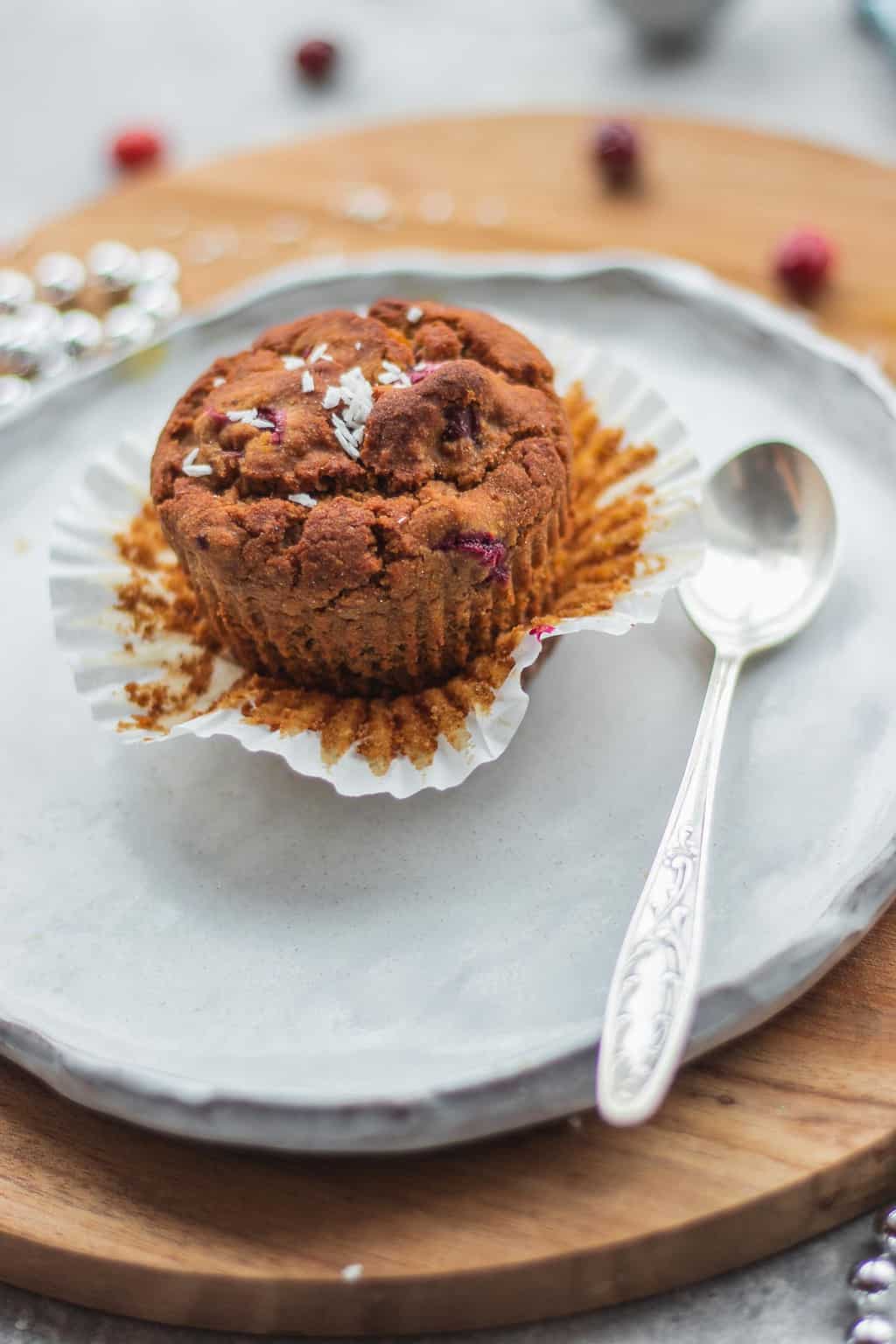 cranberry orange muffin being served on a white plate