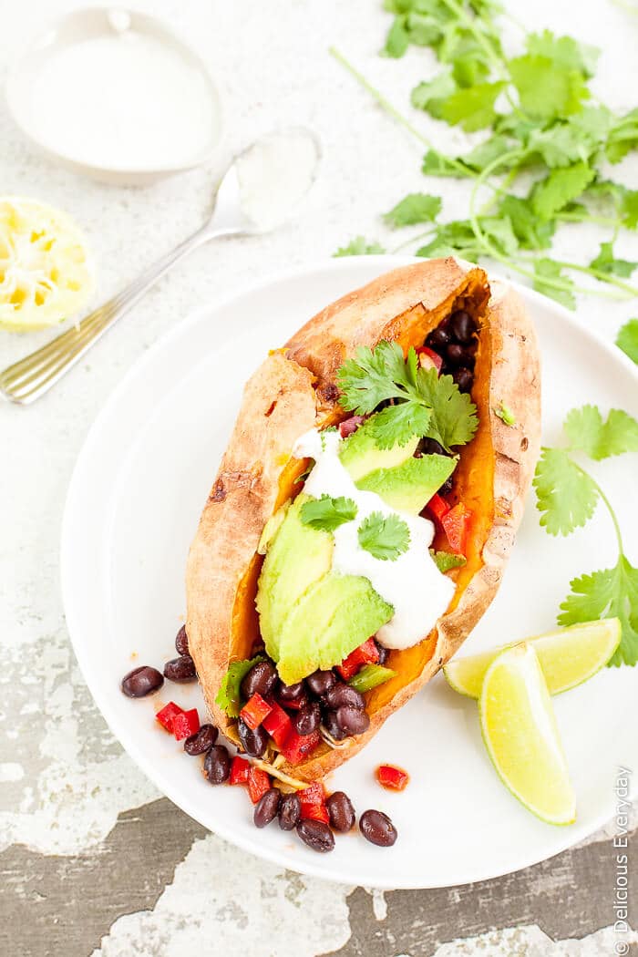 loaded sweet potato being served on a white dish