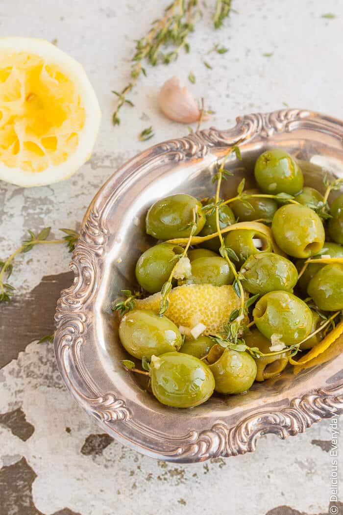 Plump green Sicilian olives are marinated in lemon zest and juice, garlic and thyme for a totally addictive and delicious treat. | Click for the recipe 