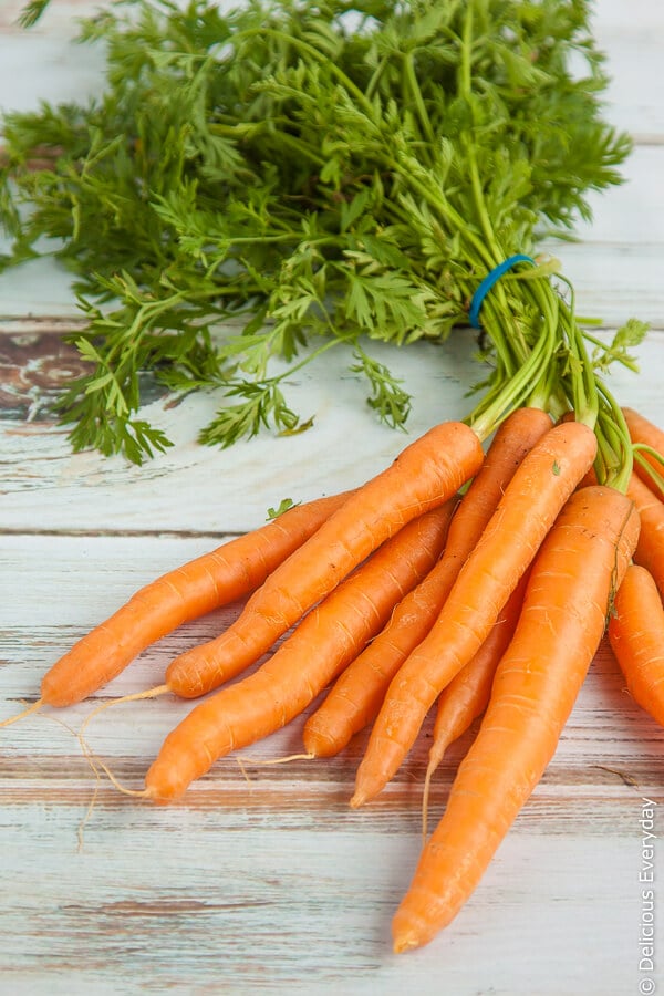 baby carrots with their green tops still attached