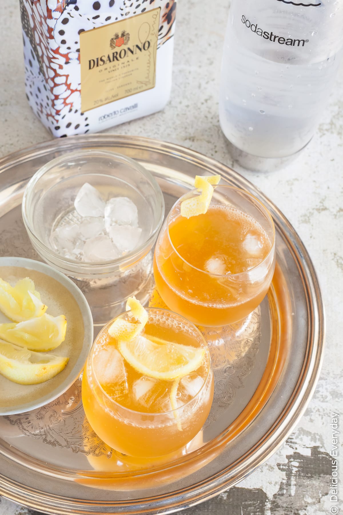 two amaretto sour cocktails on a serving platter