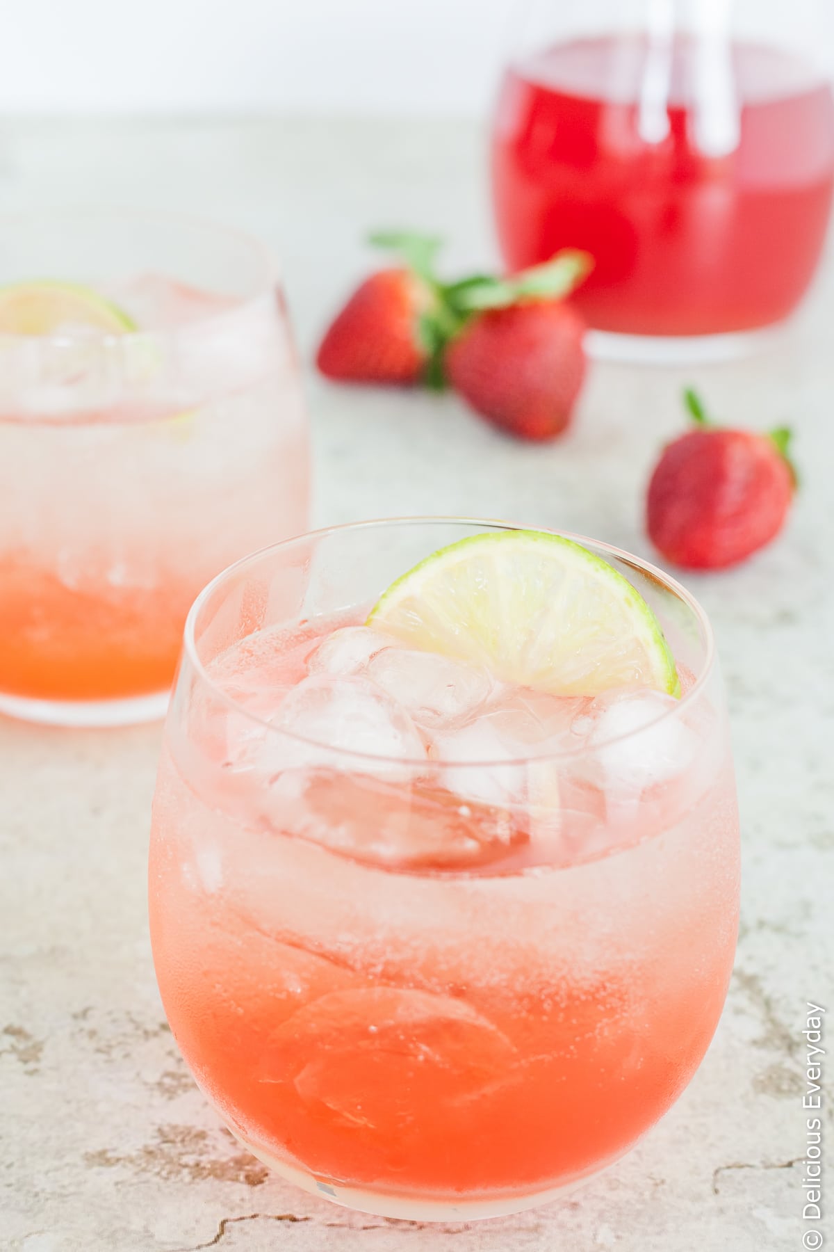 A beautiful homemade simple syrup (or cordial) made from fresh strawberries, rhubarb and lime. Add this gorgeous strawberry, lime and rhubarb syrup to sparkling water for a wonderful refreshing drink which also works wonderfully with a splash of gin! | Click for the recipe