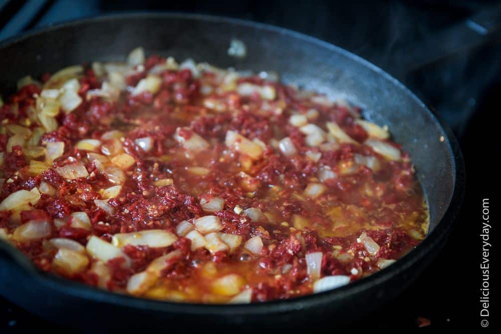 sun dried tomatoes and onions in cast iron skillet