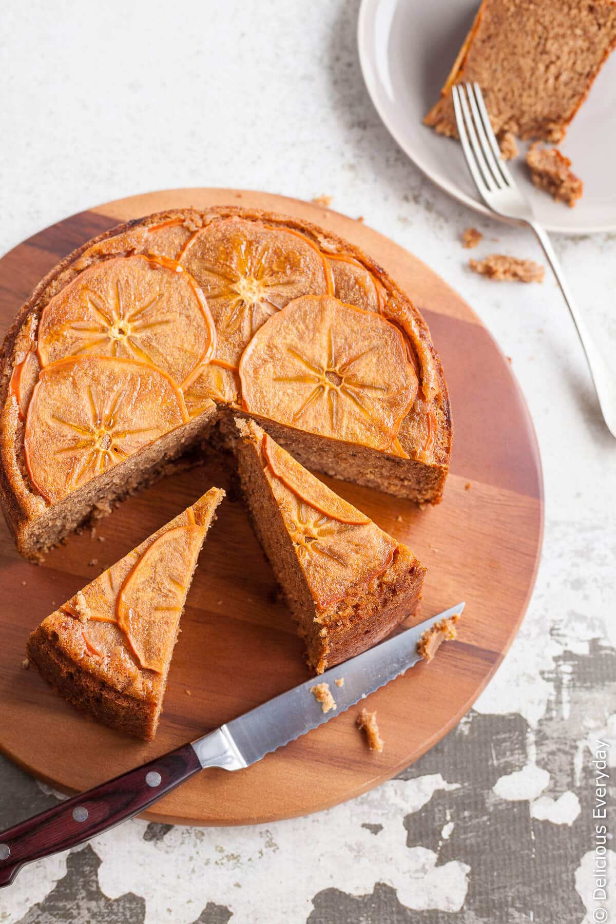 This gorgeous spiced upside down persimmon cake topped with finely sliced persimmon in maple syrup is a great introduction to persimmons. | Click for the recipe