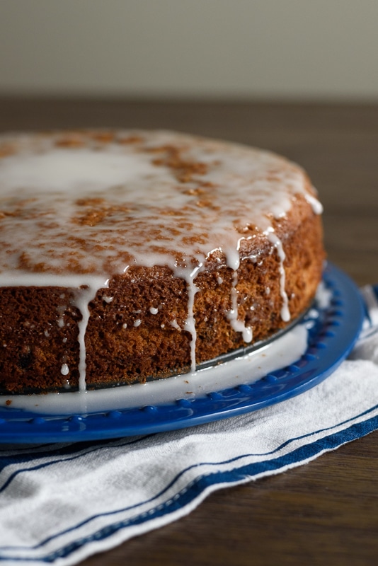 blueberry lemon yogurt cake with icing on a blue plate