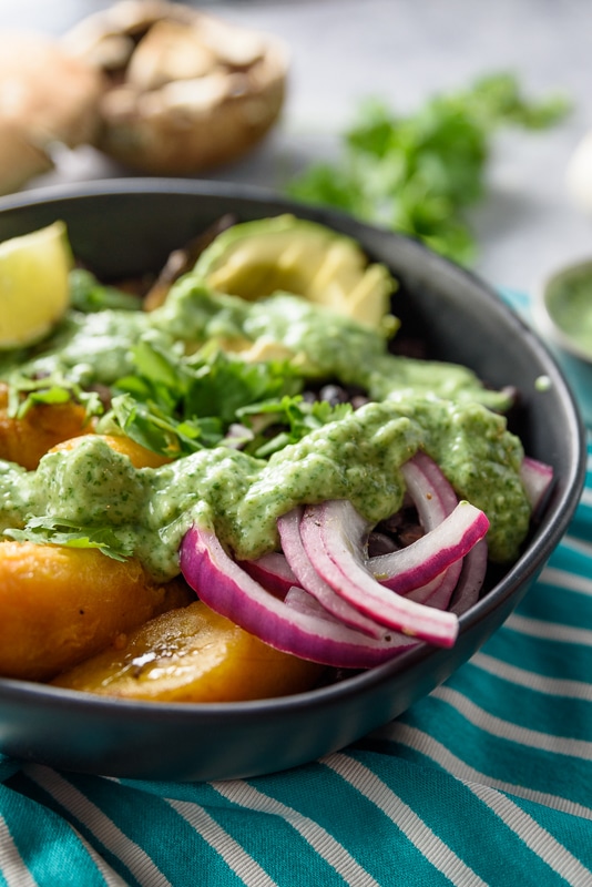 close up of vegan buddha bowl in black serving dish 