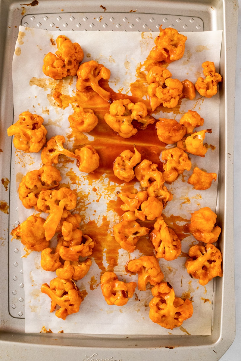 baked buffalo cauliflower on a baking sheet