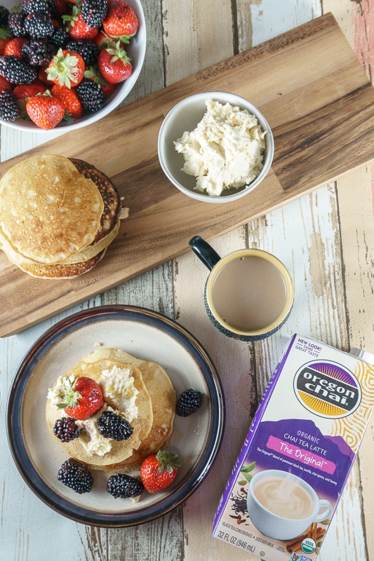 chai spiced pancakes on a table with chai tea latte