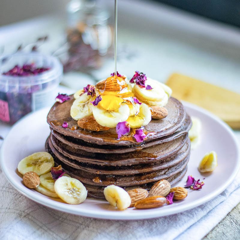 vegan pancakes with syrup pouring over