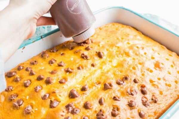 filling holes in cake with chocolate pudding