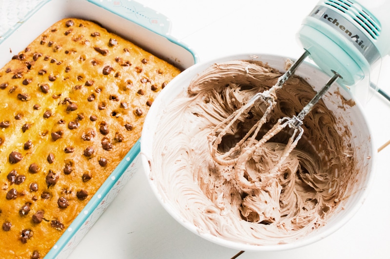 mixing chocolate cream cheese frosting for chocolate poke cake