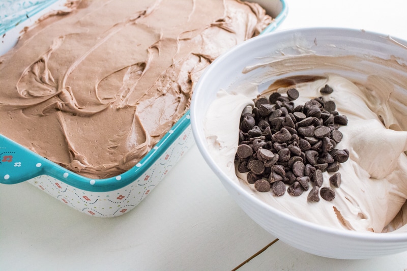 mixing whipped cream topping for chocolate poke cake